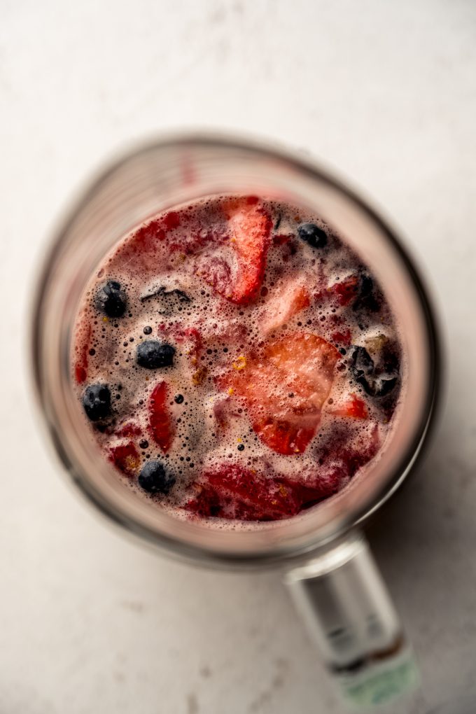 Aerial photo of berry sangria in a glass pitcher.