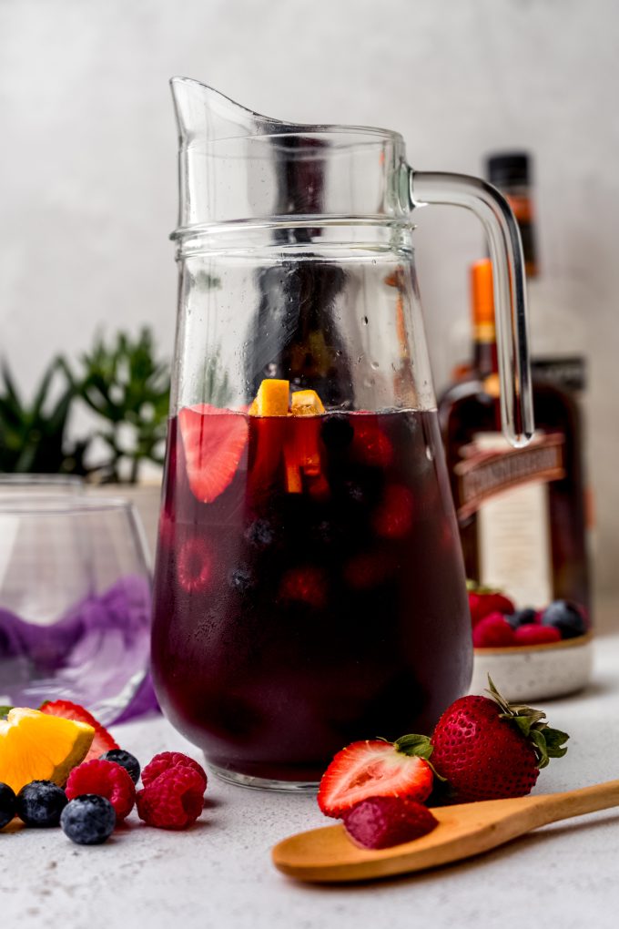 A glass pitcher of berry sangria.