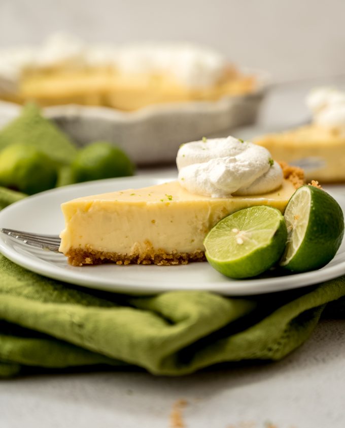 A photo of a slice of Key lime pie on a plate with a fork.
