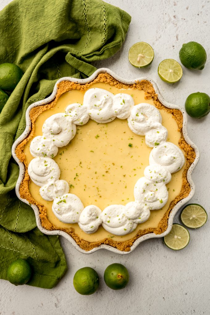 Aerial photo of a Key lime pie garnished with whipped cream.