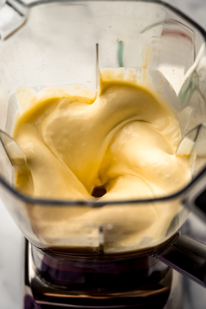 Aerial photo of a blender canister with passion fruit mousse ingredients in it.