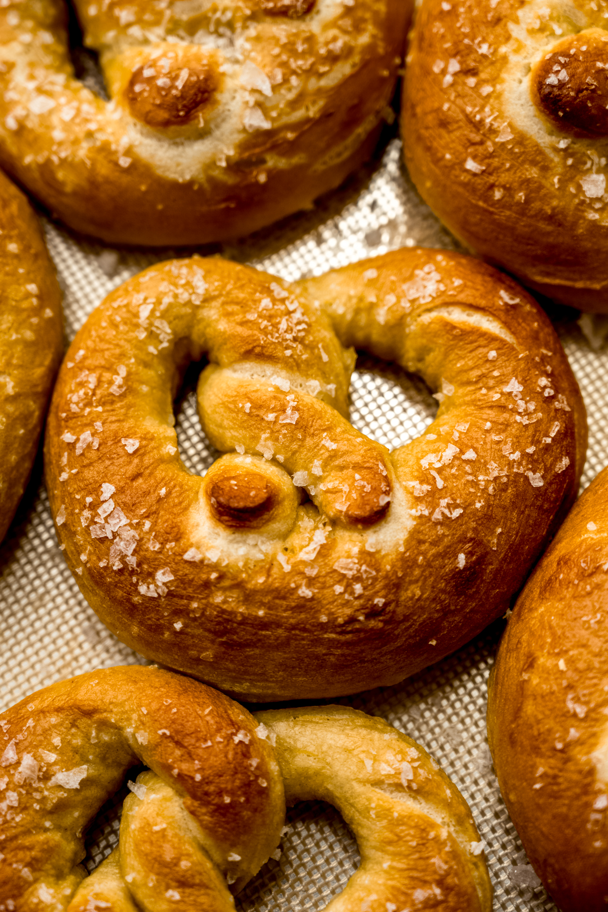 Homemade soft pretzels on a surface.