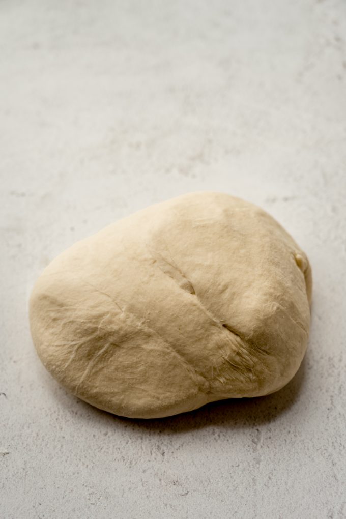 Homemade pretzel dough on a surface.