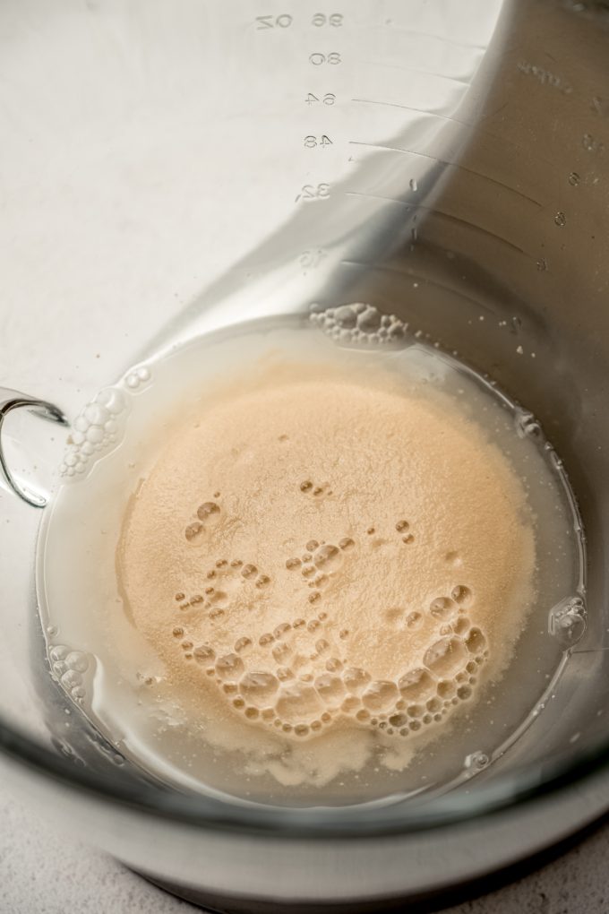 Proofed yeast in the bottom of a stand mixer bowl.