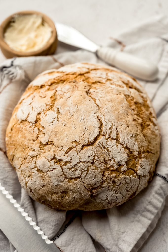 A loaf of no knead bread on a surface.