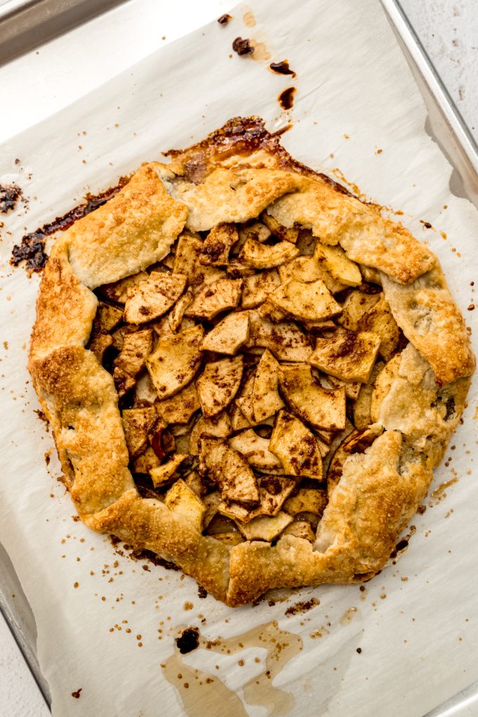 Aerial photo of an apple galette on a baking sheet.