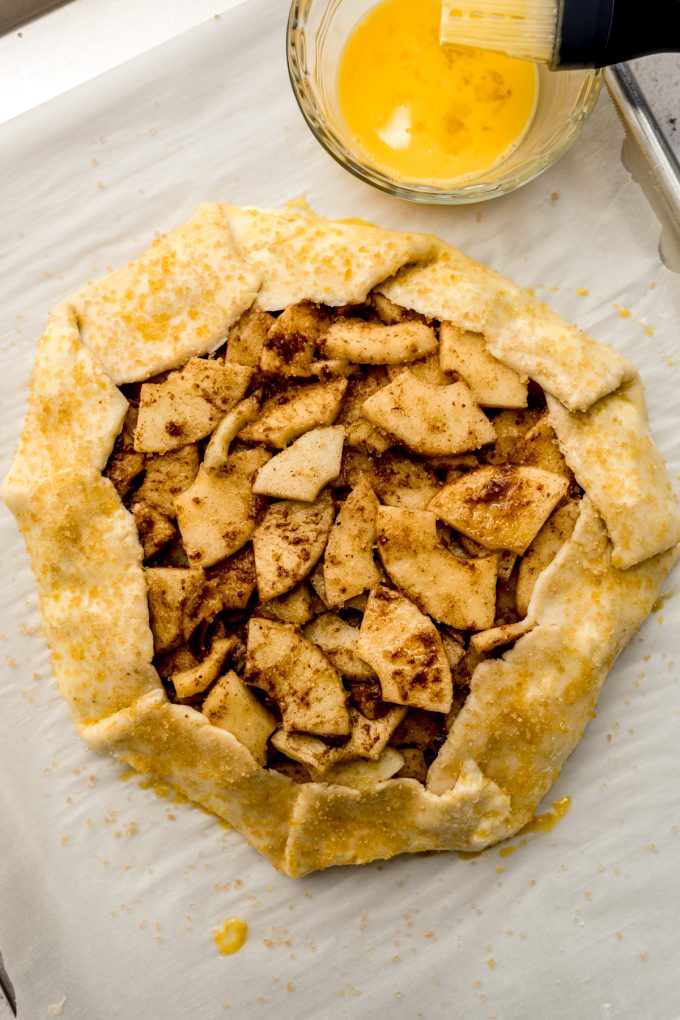 Aerial photo of an apple galette on a baking sheet.