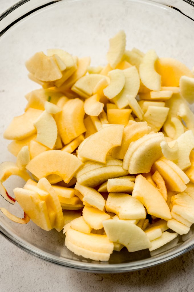 Sliced apples in a large glass bowl.