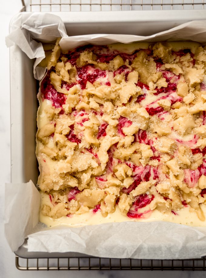 Aerial photo of raspberry cheesecake bars in a baking pan before getting baked.